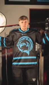 a man in a hockey jersey holding a hockey bat